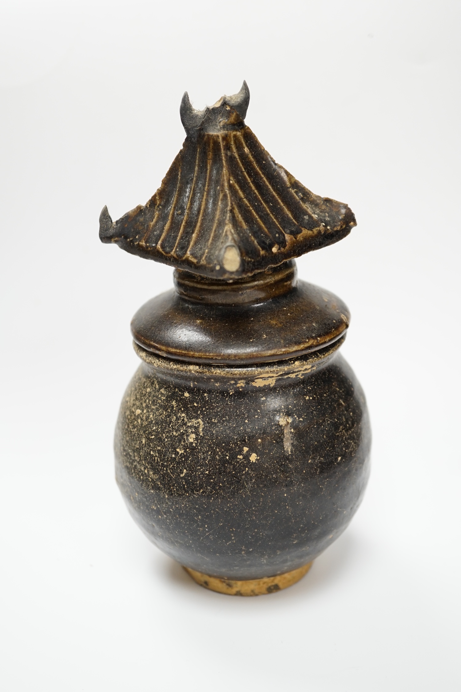 A Khmer brown glazed jar and cover, Cambodia, 12th century, 18cm